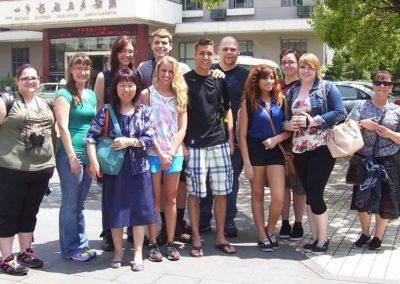 Dr. Youyu Phillips pictured with students and faculty and staff on a study abroad trip to China.