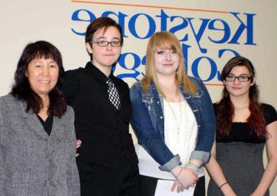 Dr. Youyu Phillips pictured with three members of the Anime Intelligence club.